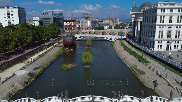 Aerial drone video on Vardar River showing riverside in Skopje in North Macedonia