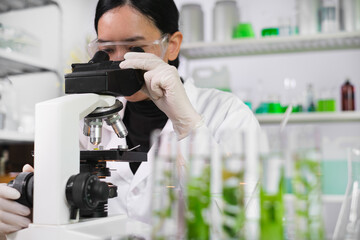 Scientist or student of biology researcher and scientist doing the biotechnology experiment in laboratory, scientist using microscope inspecting a science sampling. Plant lab chemical medicine.