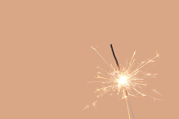 Beautiful Christmas sparkler on brown background