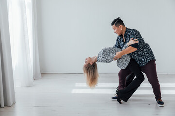 dancers man and woman kizomba bachata Latin salsa in a dance studio