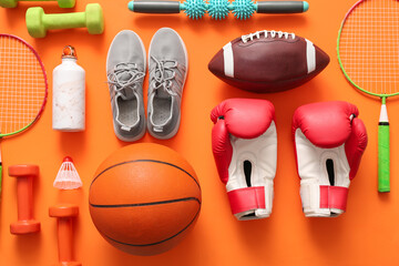 Different sports equipment on orange background
