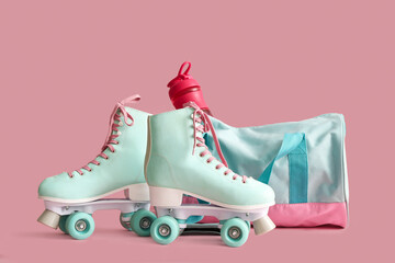 Fototapeta Bag with sports bottle and roller skates on pink background obraz