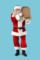 Santa Claus with box of tasty pizza on blue background
