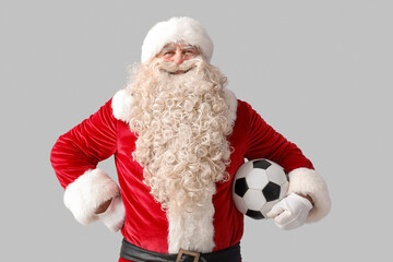 Santa Claus with soccer ball on white background