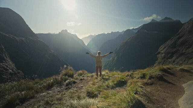 Cheerful woman spreading arms and looking around panoramic view, Gertrude Saddle