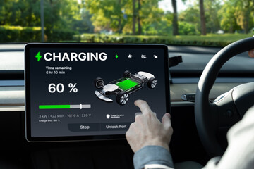 Electric car driver checks battery charging status, range and charging limit on app screen in the car. Smart technology device show EV car recharging data of electric storage in car battery innards.
