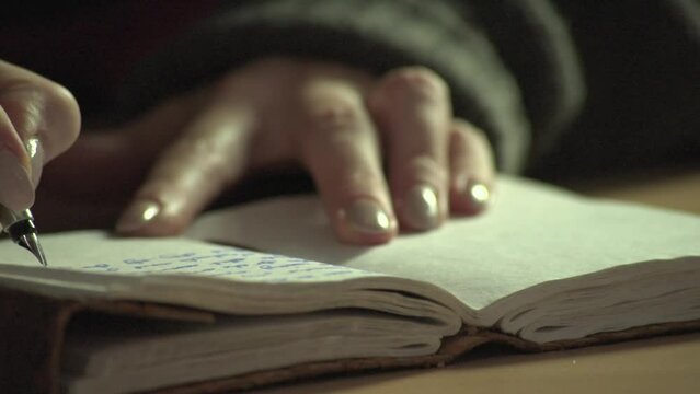 Close-up of fountain pen writing in an old-fashioned paper notebook or diary