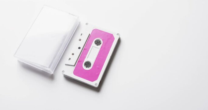 Video of retro tape with pink label and clear box with copy space on white background