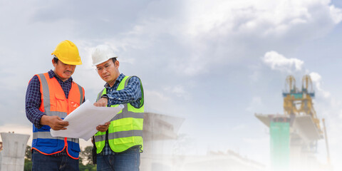 Engineer and foreman worker checking project at building site, Engineer and builders in hardhats...