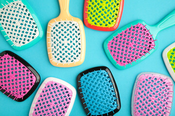 Set of hairbrushes on blue background. Flat lay