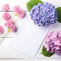 colorful hydrangea flowers and card on white wooden table for greeting holiday card decor