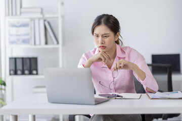 Tired exhausted or sad business young asian woman sleepy and bored from sitting at a desk.tired of working in a laptop,