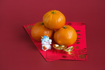 Happy New Year Chinese of the dragon 2024. Mandarin orange, dragon on red envelopes isolated on red...