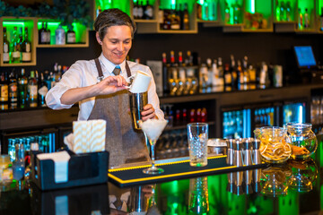 A professional bartender making luxury cocktail in the counter