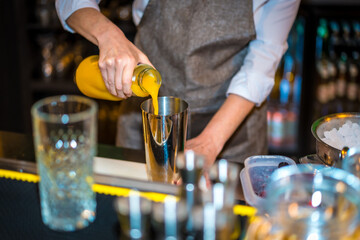 Bartender using juice to prepare a luxury cocktail