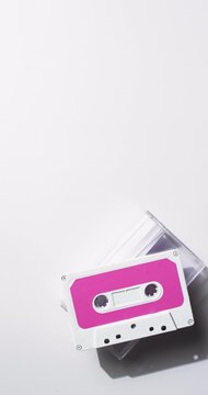Vertical video of retro tape with pink label and copy space on white background