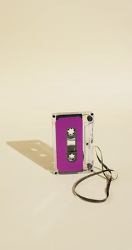 Vertical video of retro tape with pink label and copy space on yellow background