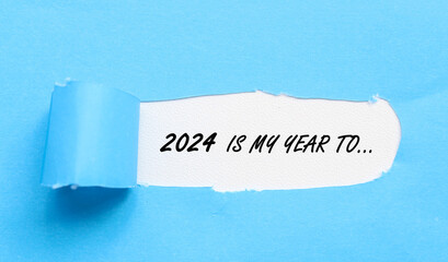 Words 2024 is my year to on white background and torn blue paper. 2024 new year torn paper concept