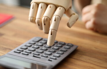 Close-up of person with prosthesis hand calculating. Businessman accounting budget. People with...