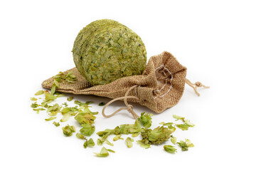Small jute bag with dried hops (pressed hop puck) photographed on white background