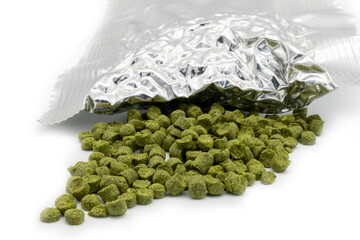 Aluminium bag with vacuumed hop granules with a pile of green hop pellets - Žatec, Czech Republic