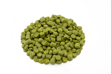 Pile of green hops pellets on white background.