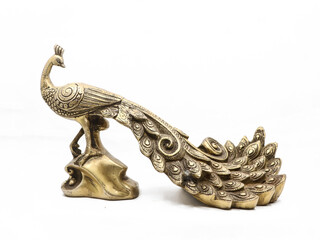 golden male peacock figurine with stand handcrafted and decorated with ornate details isolated in a white background