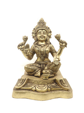 frontb view of a brass idol of hindu goddess lakshmi stitting with multiple arms, symbol of wealth and prosperity isolated 