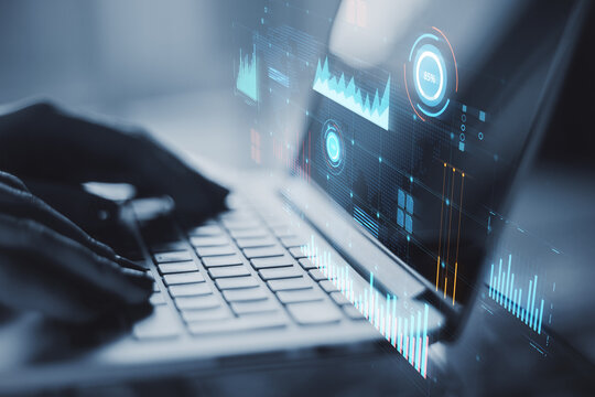 Laptop with digital financial data analysis on blue holographic screen