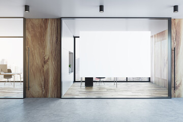 Modern glass office hall interior with empty white mock up banner, wooden and concrete walls,...