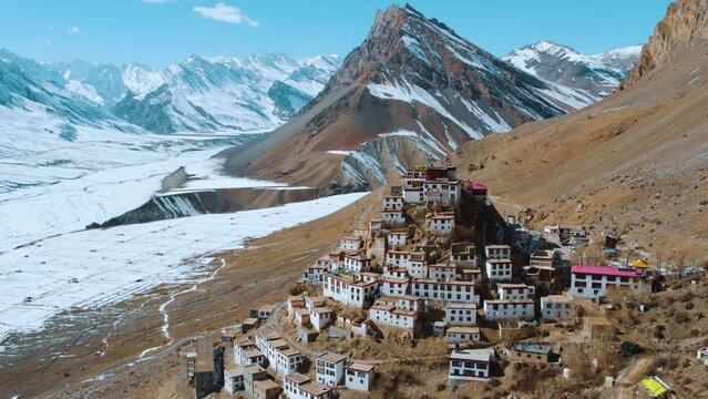 A beautiful aerial drone shot of ancient and famous tourist destination of Spiti Valley, India. Key monastery aerial view. Buddhist monastery is surrounded by snowy Himalayan mountains during winter.