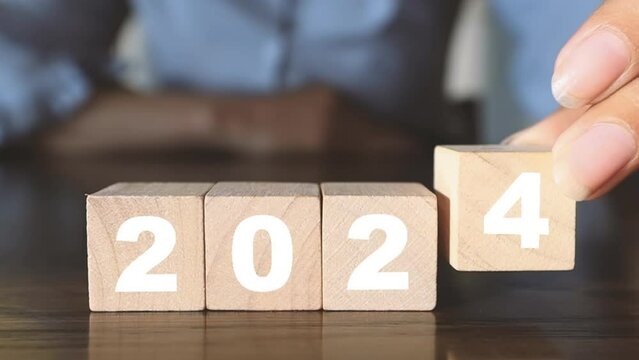 Changing wooden blocks from 2000 to 2024 idea, business, goals, resolutions, strategy, roadmap, startup company, budget, mission, motivation, calendar, growth, success, Christmas and Happy New Year.