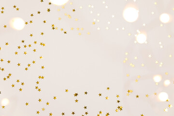 Festive gold background. Shining stars confetti and fairy lights on beige and Set Sail Shampagne...
