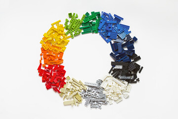 Obraz premium Lot of colorful rainbow toy bricks in circle shape on white. Diagram toy building block, bricks. Graph, chart, statistic. Top view. Lego blocks. Novosibirsk, Russia - October 26, 2023.