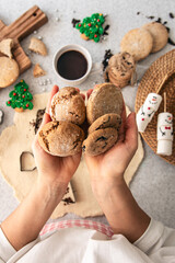 Homemade cookies in female hands, Christmas baking, top view.