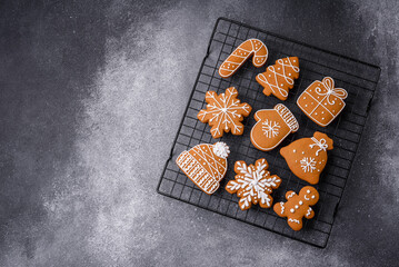 Beautiful delicious sweet winter Christmas gingerbread cookies on a gray textured background