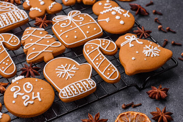 Beautiful delicious sweet winter Christmas gingerbread cookies on a gray textured background