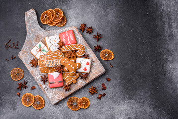 Beautiful delicious sweet winter Christmas gingerbread cookies on a gray textured background
