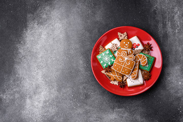 Beautiful delicious sweet winter Christmas gingerbread cookies on a gray textured background