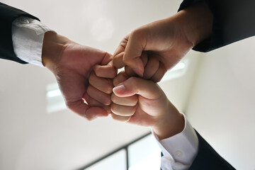 Businesspeople giving fist bump at meeting. Concept of corporate unity, motivating, solidarity, trust