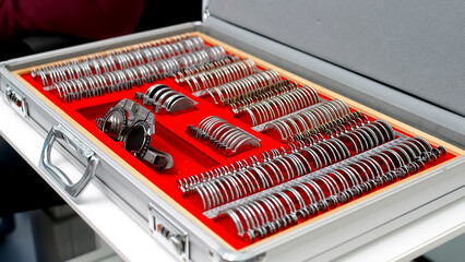 Case containing a set of trial spectacle lenses for an optometrist, finished in red velvet. Determination of myopia, farsightedness, astigmatism. 