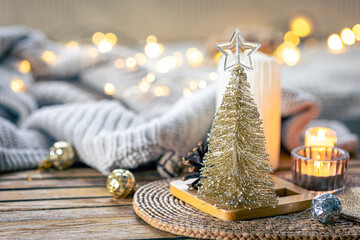 Christmas composition with a decorative small fir tree with bokeh lights.