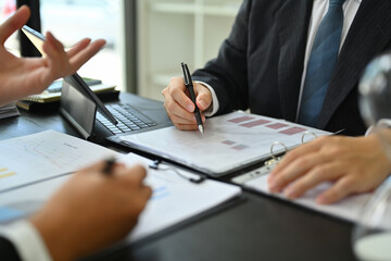Business team discussing project details and business plan at co working space in office