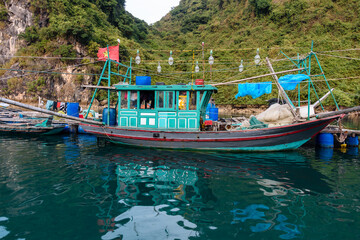 Fototapeta na wymiar A squid boat, lined with powerful bulbs at the Cua Van floating village, Halong Bay, Vietnam
