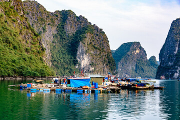 Makeshift homes on floating platforms at the Cua Van floating village, Halong Bay, Vietnam