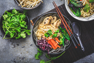 Vegan miso noodle soup with mushrooms, red cabbage, carrots and sprouts