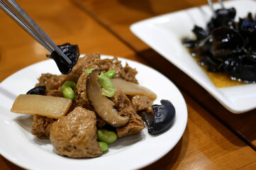 Motion of people eating appetizers on table inside Chinese restaurant