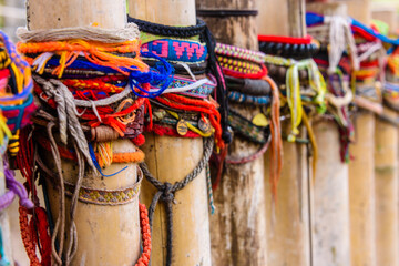 Colourful bracelets left by visitors at the site of a mass grave, Choeung Ek Killing Fields...