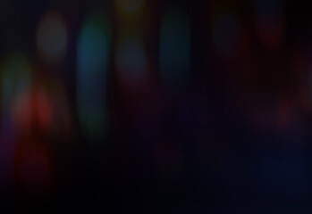 unfocused multi colored light in motion on a dark background