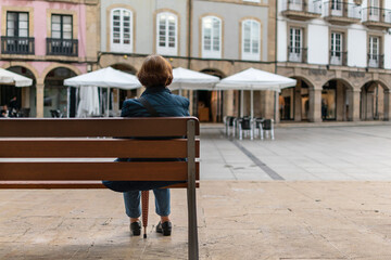 Woman sitting in the Plaza de España in Aviles, Asturias